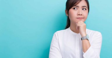 Asian woman thinking on isolated background